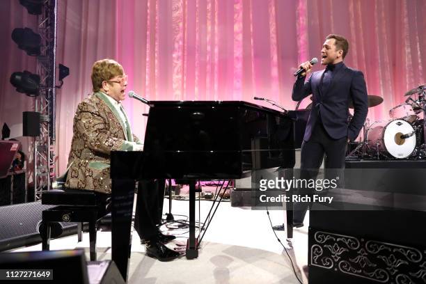 Sir Elton John and Taron Egerton perform onstage during the 27th annual Elton John AIDS Foundation Academy Awards Viewing Party sponsored by IMDb and...
