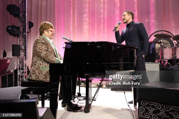 Sir Elton John and Taron Egerton perform onstage during the 27th annual Elton John AIDS Foundation Academy Awards Viewing Party sponsored by IMDb and...