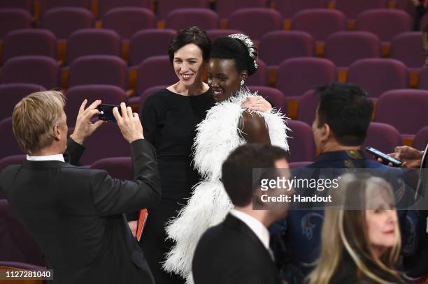 In this handout provided by A.M.P.A.S., Viggo Mortensen takes a photo of Ariadna Gil and Lupita Nyong'o after the 91st Annual Academy Awards at the...