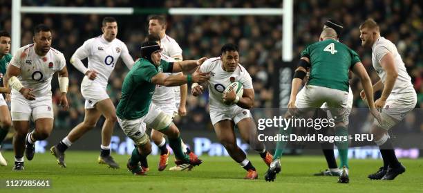 Manu Tuilagi of England moves past CJ Stander during the Guinness Six Nations match between Ireland and England at Aviva Stadium on February 02, 2019...