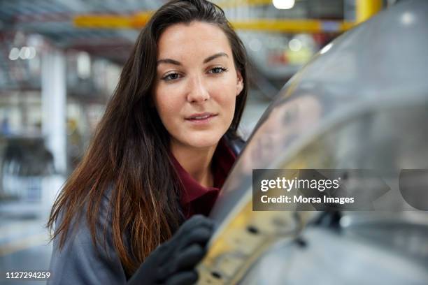 close-up of engineer examining car in industry - robot and car factory stock pictures, royalty-free photos & images