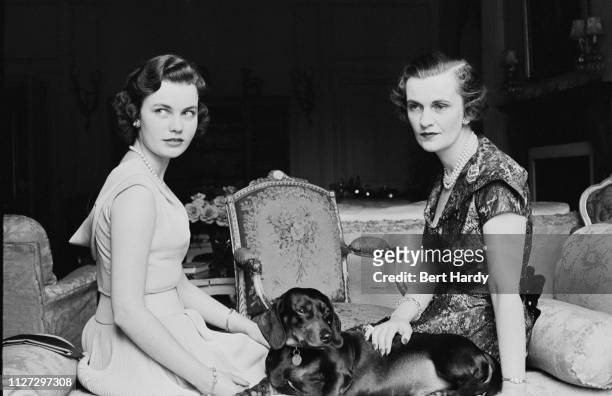 British socialite Margaret Campbell, Duchess of Argyll , with her daughter Frances Helen Sweeney, and a dachshund, UK, 6th August 1955. Original...