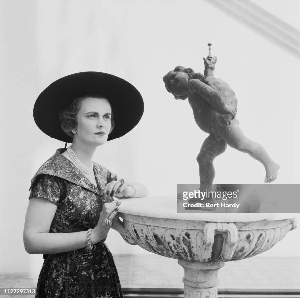 British socialite Margaret Campbell, Duchess of Argyll wearing printed dress and Gainsborough hat, UK, 6th August 1955. Original Publication: Picture...