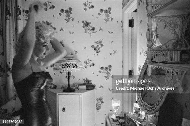 American actress Marilyn Monroe in her room at the Ambassador Hotel, New York City, 24th March 1955. She is getting ready to go out to watch a...