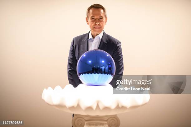 Artist Jeff Koons poses with "Gazing Ball " for photographers during the press launch of an exhibitions of his work at the Ashmolean Museum, on...