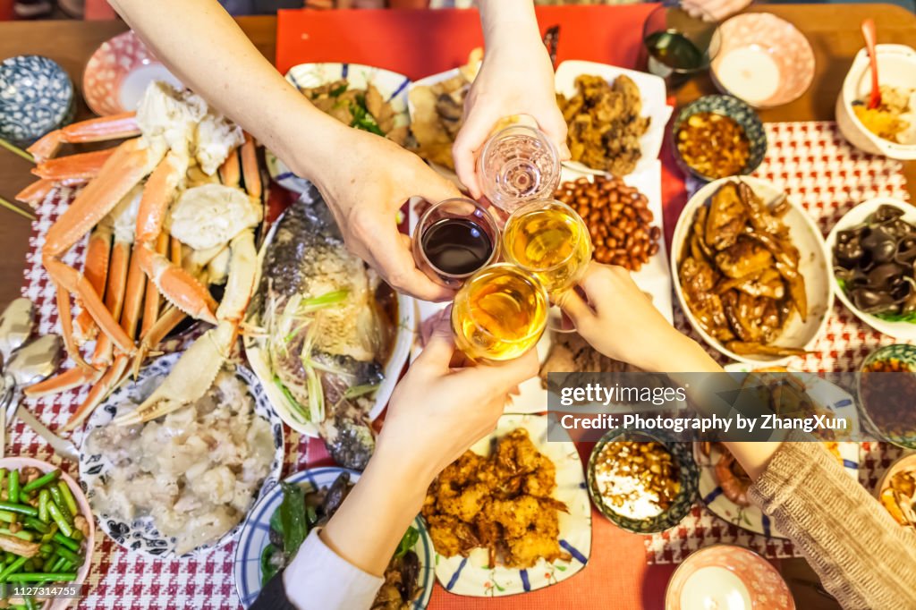 Family are toasting beers and wines over Chinese traditional dishes celebrating for Chinese new year, Tokyo, Japan.