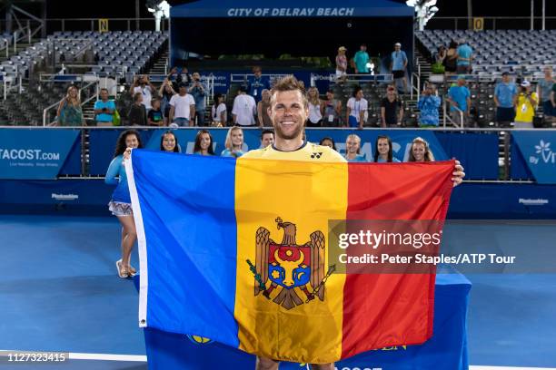 Finals champion Radu Albot of Moldova poses with the Moldova flag after defeating Daniel Evans of Great Britain at the Delray Beach Open held at the...