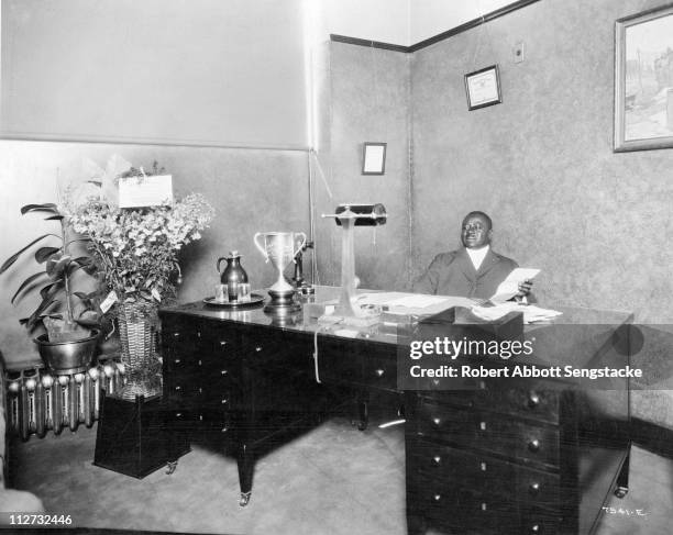 Businessman and founder of the Chicago Defender newspaper Robert Sengstacke Abbott sits in his office, 1933.