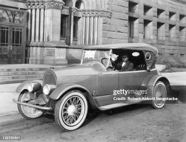 Robert Sengstacke Abbott sits in the driver's seat of the official car for the Fourth Liberty Loan drive, in support of America's efforts during...