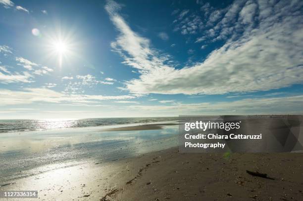 sunny day on a winter sandy beach - idillio stock pictures, royalty-free photos & images