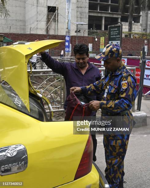 Bangladeshi security personnel search a vehicle at an entrance of the Hazrat Shahjalal International Airport in Dhaka on February 25 as Bangladesh's...