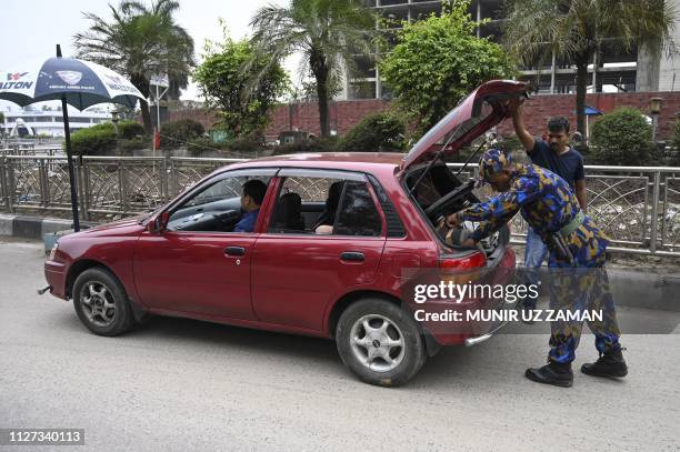 Bangladeshi security personnel search a vehicle at a road entrance to the Hazrat Shahjalal International Airport in Dhaka on February 25 as...