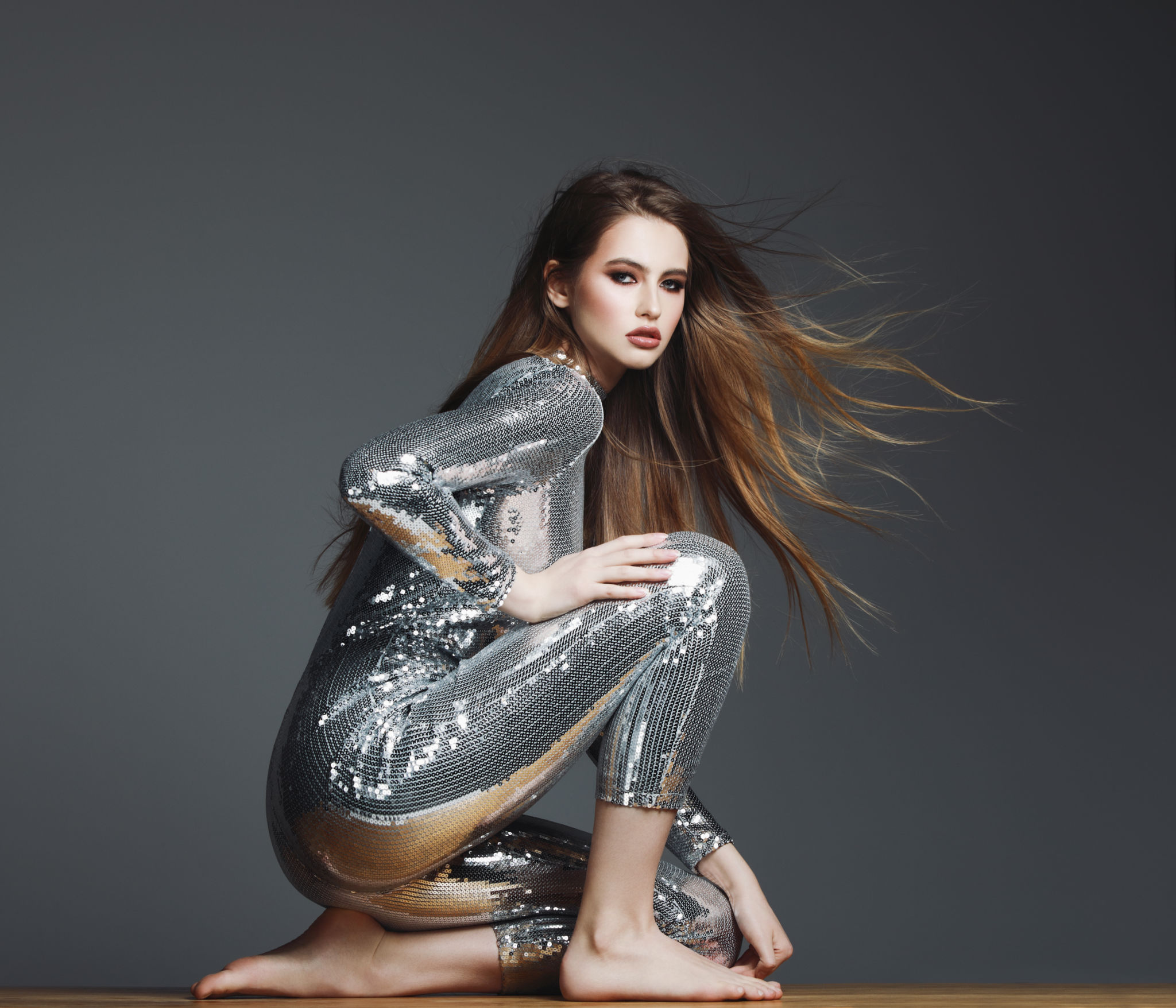Beautiful confident woman in sequin jumpsuit Beautiful confident woman in sequin jumpsuit