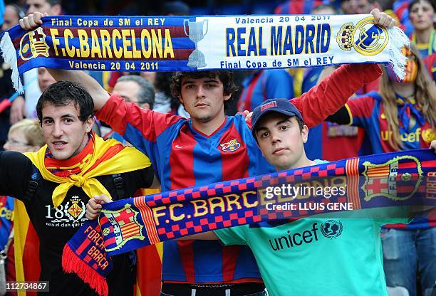 Barcelona and Real Madrid supporters cheer their team before the Spanish Cup final match Real Madrid against Barcelona at the Mestalla stadium in...