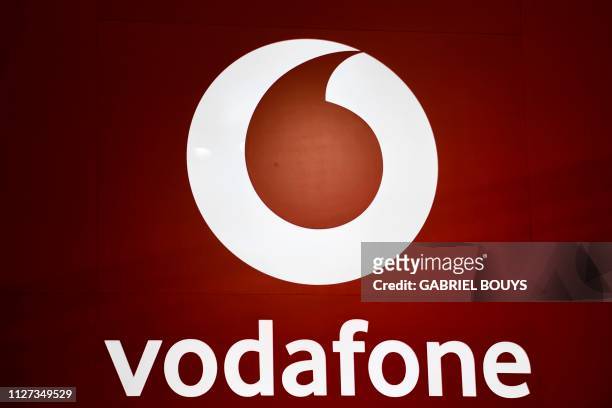 The Vodafone logo is displayed at the Mobile World Congress in Barcelona on February 25, 2019. - Phone makers will focus on foldable screens and the...