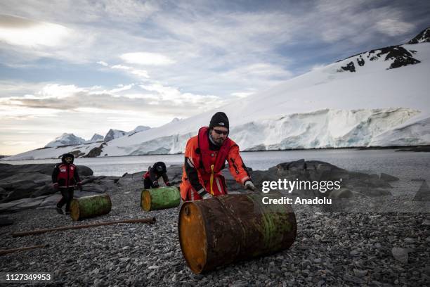 Korhan Ozkan, a faculty member of the Middle East Technical University Institute of Marine Sciences helps carry the barrels for setting up a research...