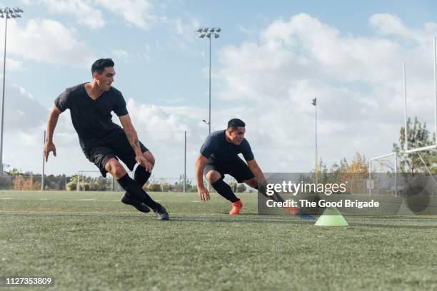 soccer players performing warm up drills on field - ejercicio de entrenamiento deportivo fotografías e imágenes de stock