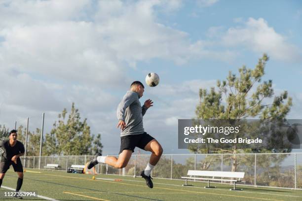 soccer player heading the ball - heading the ball stock pictures, royalty-free photos & images