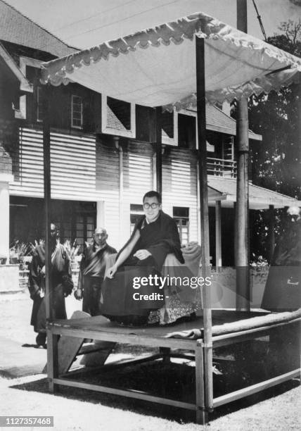 Dalai Lama , the traditional religious and temporal head of Tibet's Buddhist clergy, seats under a canopy as he celebrates, for the first time since...