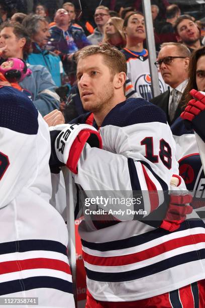 Bryan Little of the Winnipeg Jets stands for the singing of the national anthem prior to the game against the Edmonton Oilers on December 31, 2018 at...