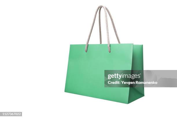 green paper shopping bags isolated on white background - shopping bag isolated stock pictures, royalty-free photos & images