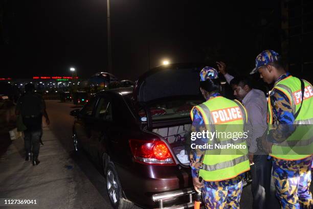 Bangladeshi security personnel search a vehicle at a road entrance to the Hazrat Shahjalal International Airport in Dhaka on February 24 as...