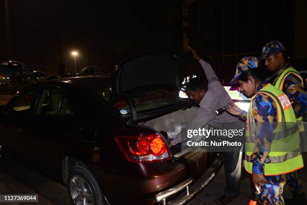 Bangladeshi security personnel search a vehicle at a road entrance to the Hazrat Shahjalal International Airport in Dhaka on February 24 as...