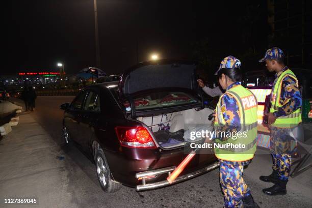 Bangladeshi security personnel search a vehicle at a road entrance to the Hazrat Shahjalal International Airport in Dhaka on February 24 as...