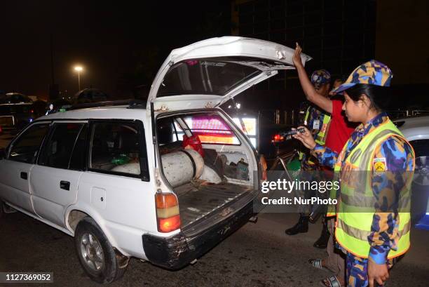 Bangladeshi security personnel search a vehicle at a road entrance to the Hazrat Shahjalal International Airport in Dhaka on February 24 as...