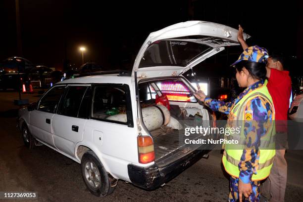 Bangladeshi security personnel search a vehicle at a road entrance to the Hazrat Shahjalal International Airport in Dhaka on February 24 as...