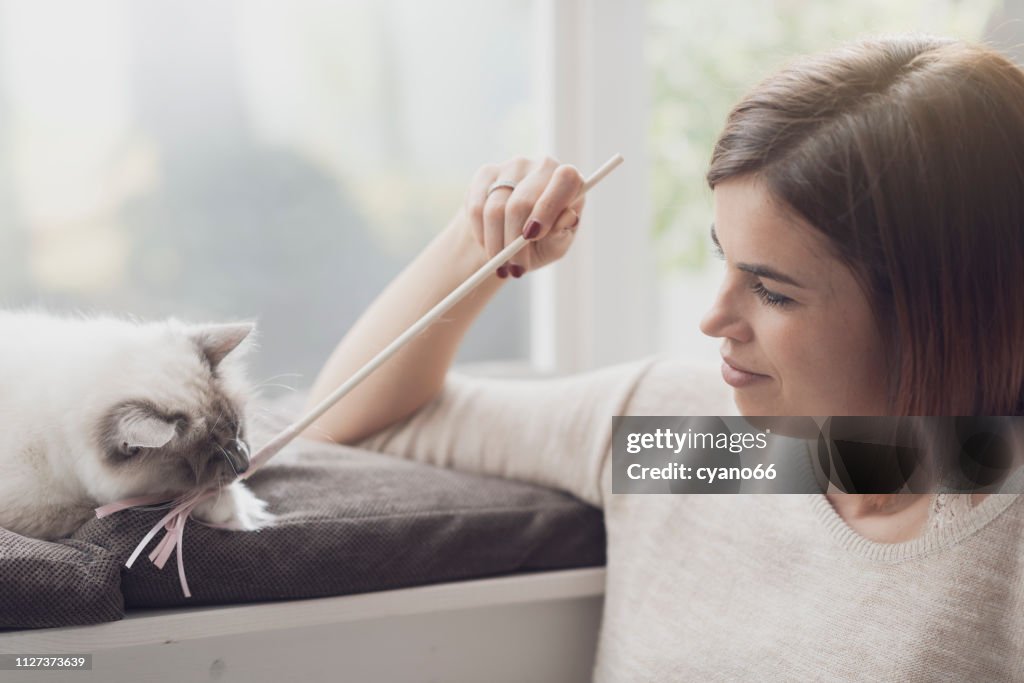 Woman playing with her cat