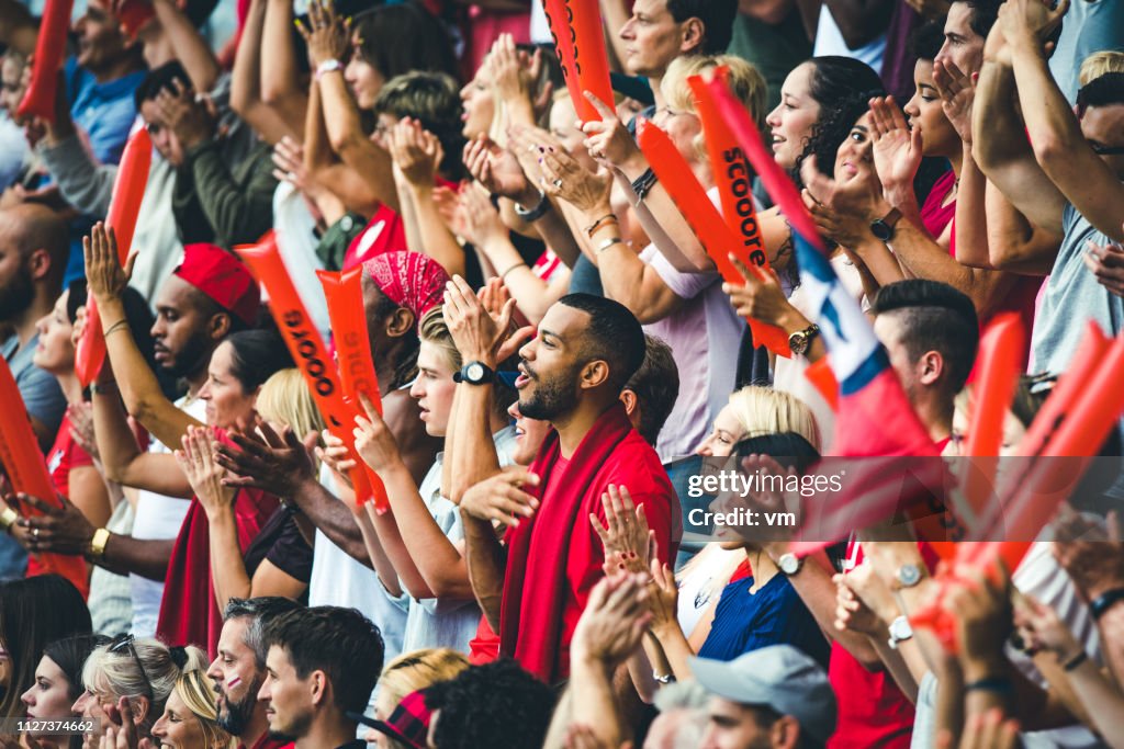 Crowd cheering for their team and clapping