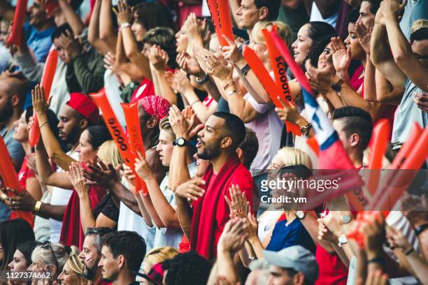 crowd cheering for their team and clapping - fans fussball stadium stock pictures, royalty-free photos & images