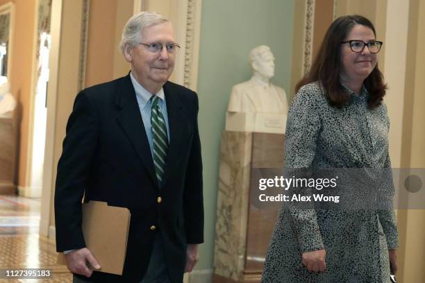 Senate Majority Leader Sen. Mitch McConnell walks towards the Senate chamber with Secretary for the Majority Laura Dove at the U.S. Capitol February...
