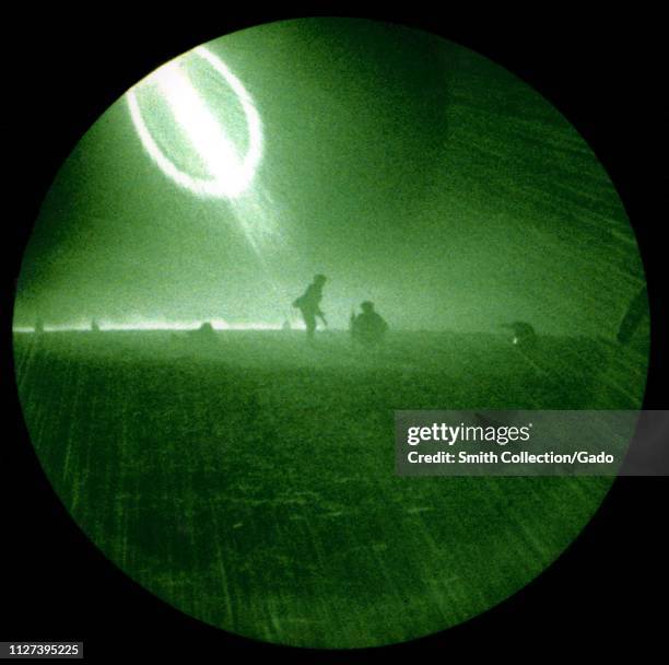 Night vision scope view as Infantry Marines from 1st Battalion, 4th Marines, conduct a night assault on targets at Al Qatrana, Jordan during exercise...