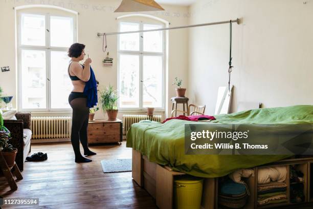 curvy woman deciding what to wear - women wearing black stockings stock pictures, royalty-free photos & images