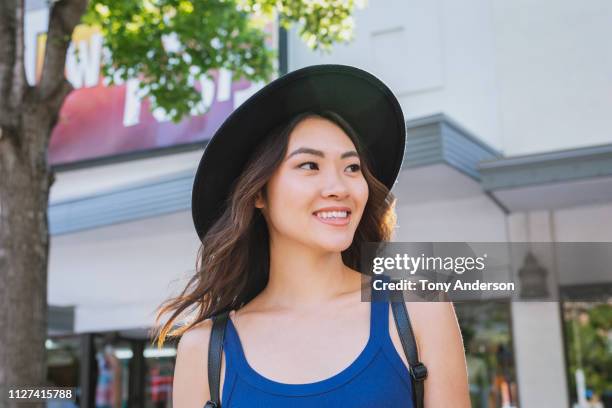 young woman on city street in summer - sleeveless top stock pictures, royalty-free photos & images