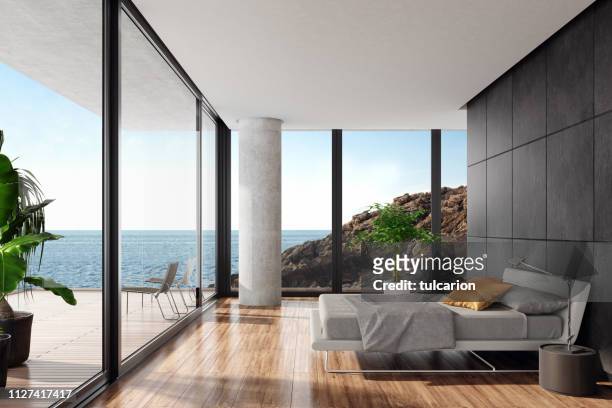dormitorio de lujo moderno en una villa de playa con pared de piedra negra - cama lujo fotografías e imágenes de stock