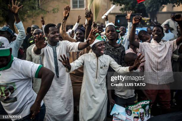 All Progressives Congress Party supporters celebrate after initial results were released by the Nigerian Independent National Electoral Commission in...