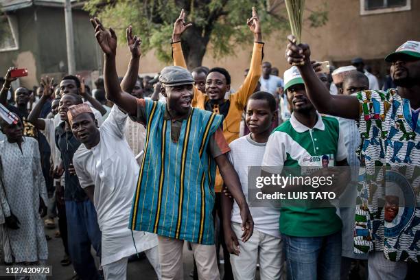 All Progressives Congress Party supporters celebrate after initial results were released by the Nigerian Independent National Electoral Commission in...