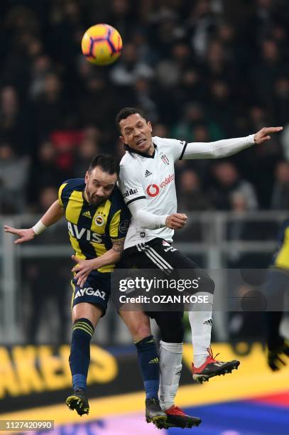 Fenerbahce's Mathieu Valbuena heads the ball next to Besiktas' Brazilian defender Adriano Correia during the Turkish Super Lig football match between...