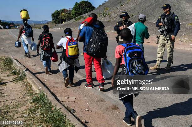 Venezuelans cross the Brazil-Venezuela border from Pacaraima, Roraima State, Brazil, into Venezuela, on February 25, 2019. - United States Vice...
