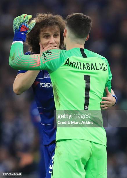 David Luiz of Chelsea relies to encourage Kepa Arrizabalaga to leave the pitch as Maurizio Sarri manager of Chelsea attempts to replace him with...