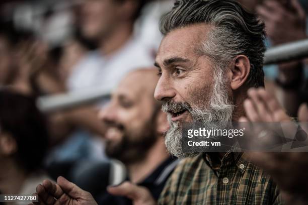 excited middle-aged man with gray hair and beard - cu fan stock pictures, royalty-free photos & images
