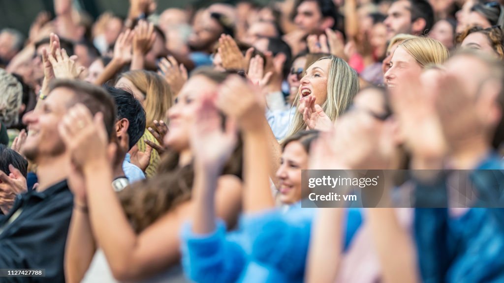 Stadium crowd cheering and clapping