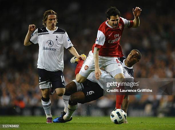 Cesc Fabregas of Arsenal is tackled by Tom Huddlestone of Spurs during the Barclays Premier League match between Tottenham Hotspur and Arsenal at...