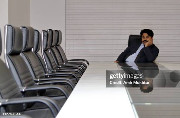 chairperson waiting for his colleagues in conference room in his office - chairperson stock pictures, royalty-free photos & images
