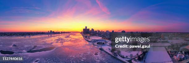 aerial view of frozen detroit river with city skyline in winter - michigan winter stock pictures, royalty-free photos & images