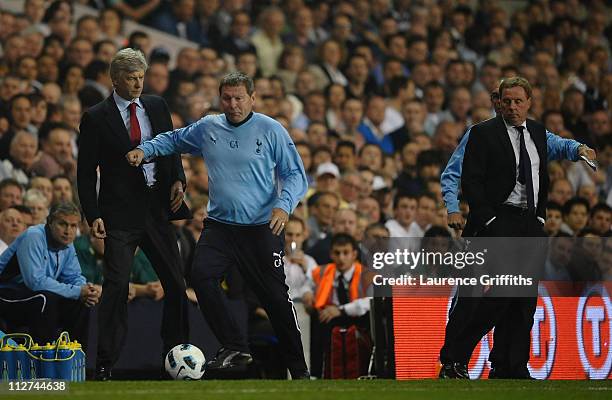 Spurs coach, Clive Allen pushes Arsenal manager Arsene Wenger out of the way during the Barclays Premier League match between Tottenham Hotspur and...