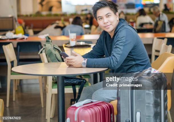 young asian japanese man travel by public transportation and waiting for plane in  airport japan - narita city stock pictures, royalty-free photos & images